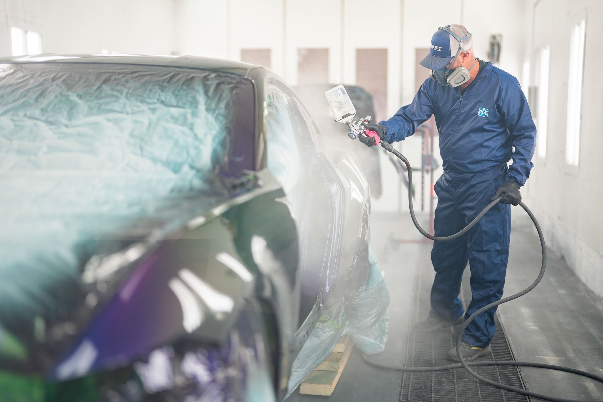 A man painting a Mystichrome Mustang RTR