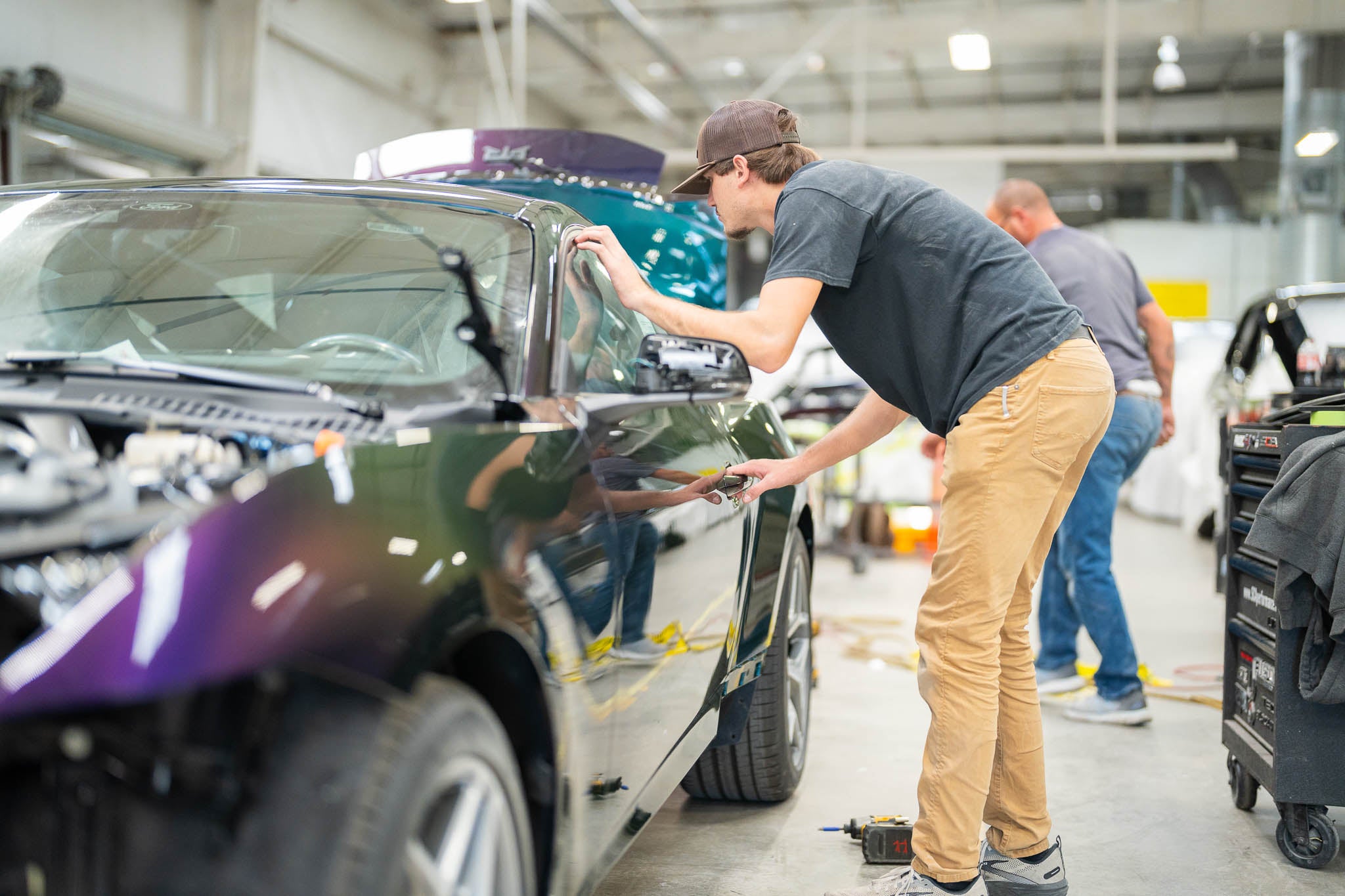 Mustang RTR being reassembled after being painted in Mystichrome