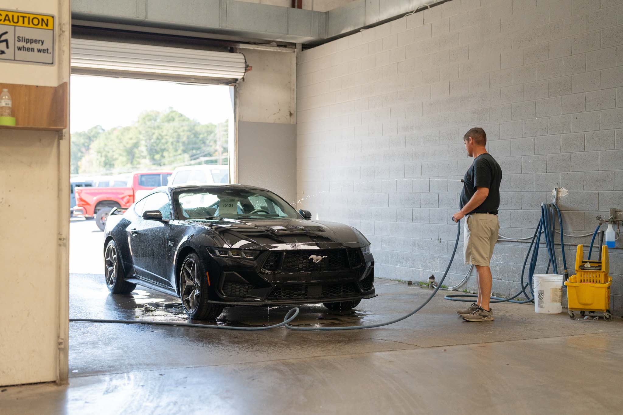 A man washes and preps a future Mystichrome Mustang RTR