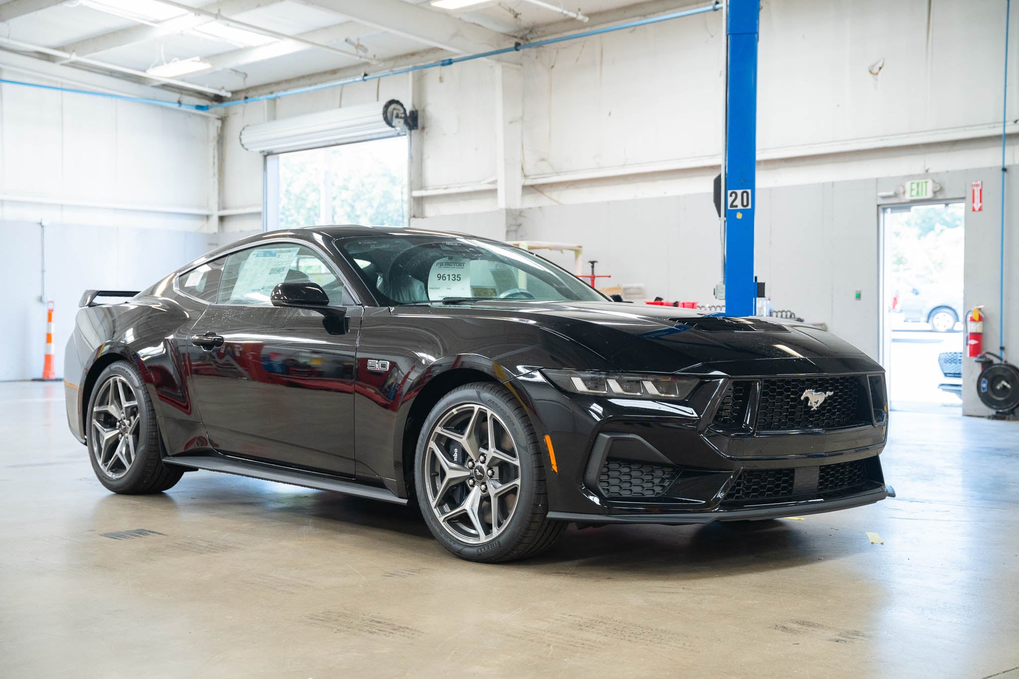 A Mustang in a shop being prepared for Mystichrome paint process