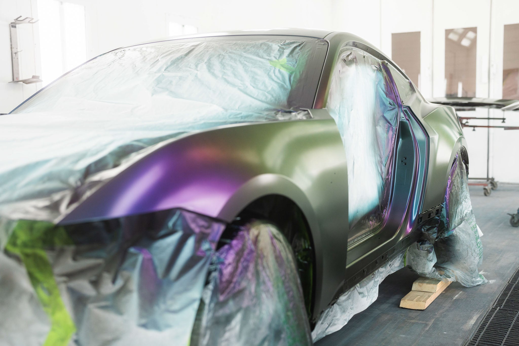 A mystichrome Mustang RTR mid paint process in a paint booth