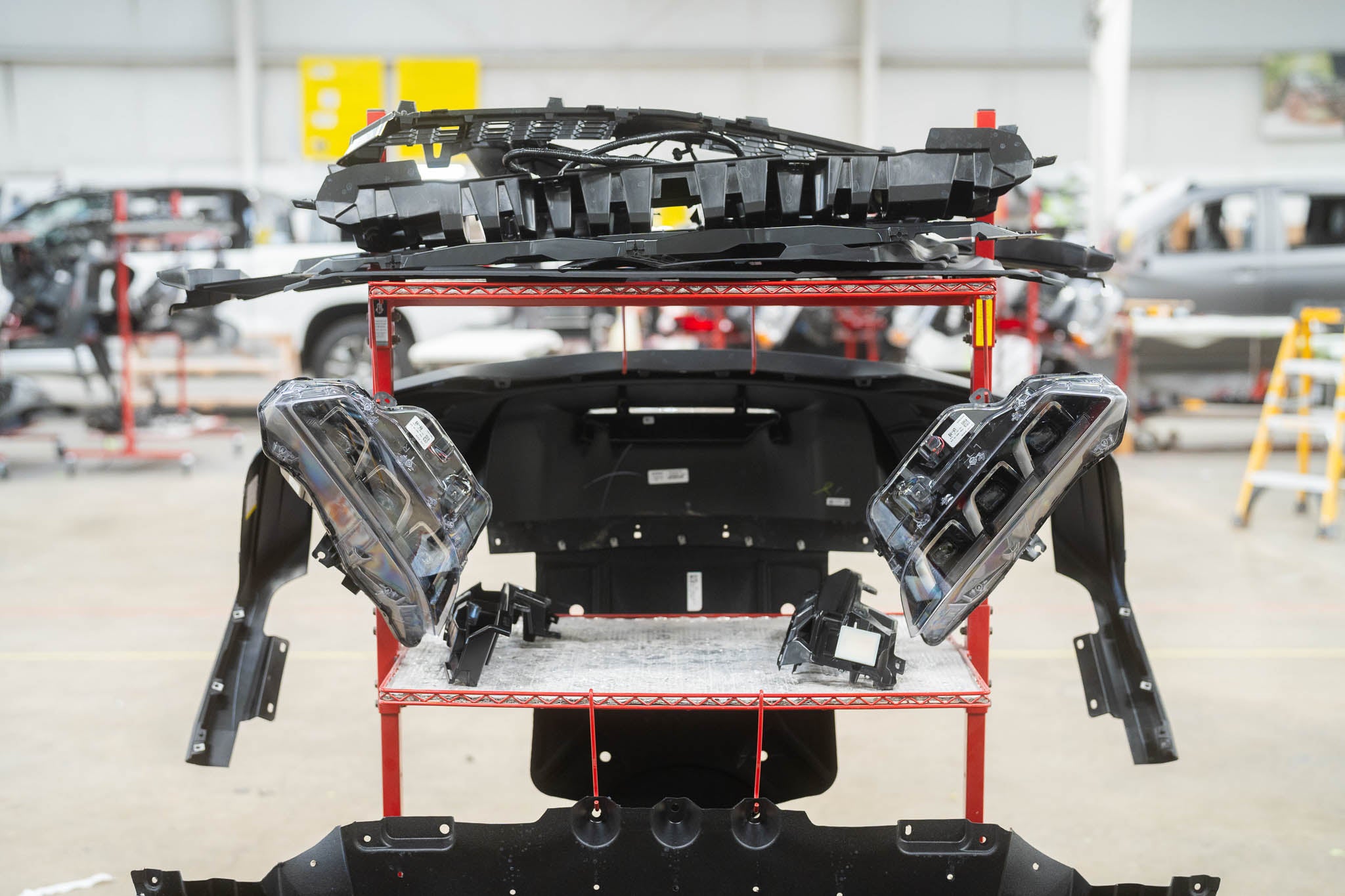 Disassembled parts on a rack from a 2025 Mustang RTR