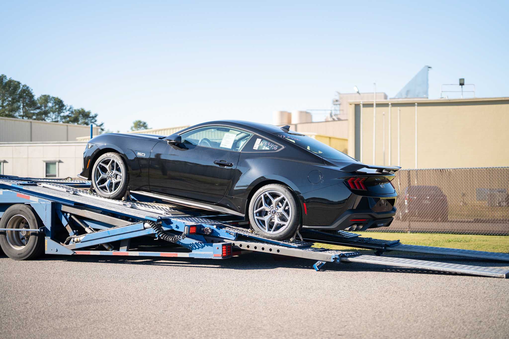 A mustang is being unloaded for the Mystichrome paint process