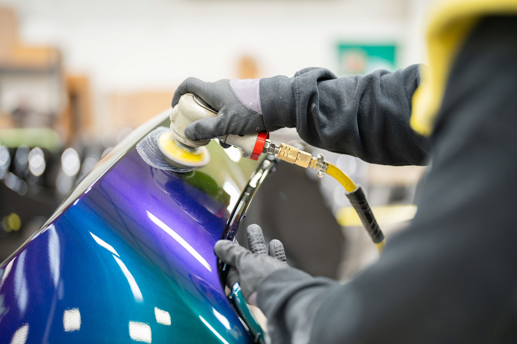 A man buffing a Musting RTR Mystichrome  fender