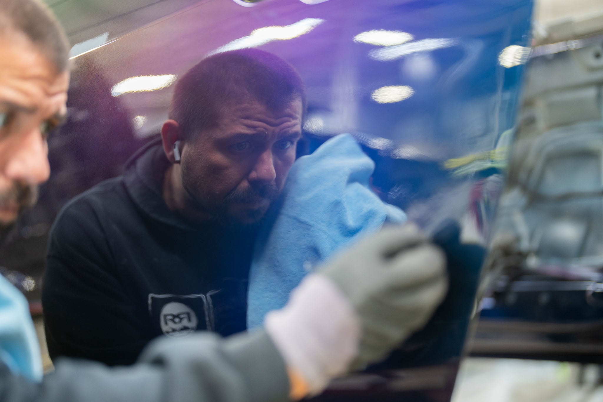 Man working on polishing a Mystichrome Mustang RTR