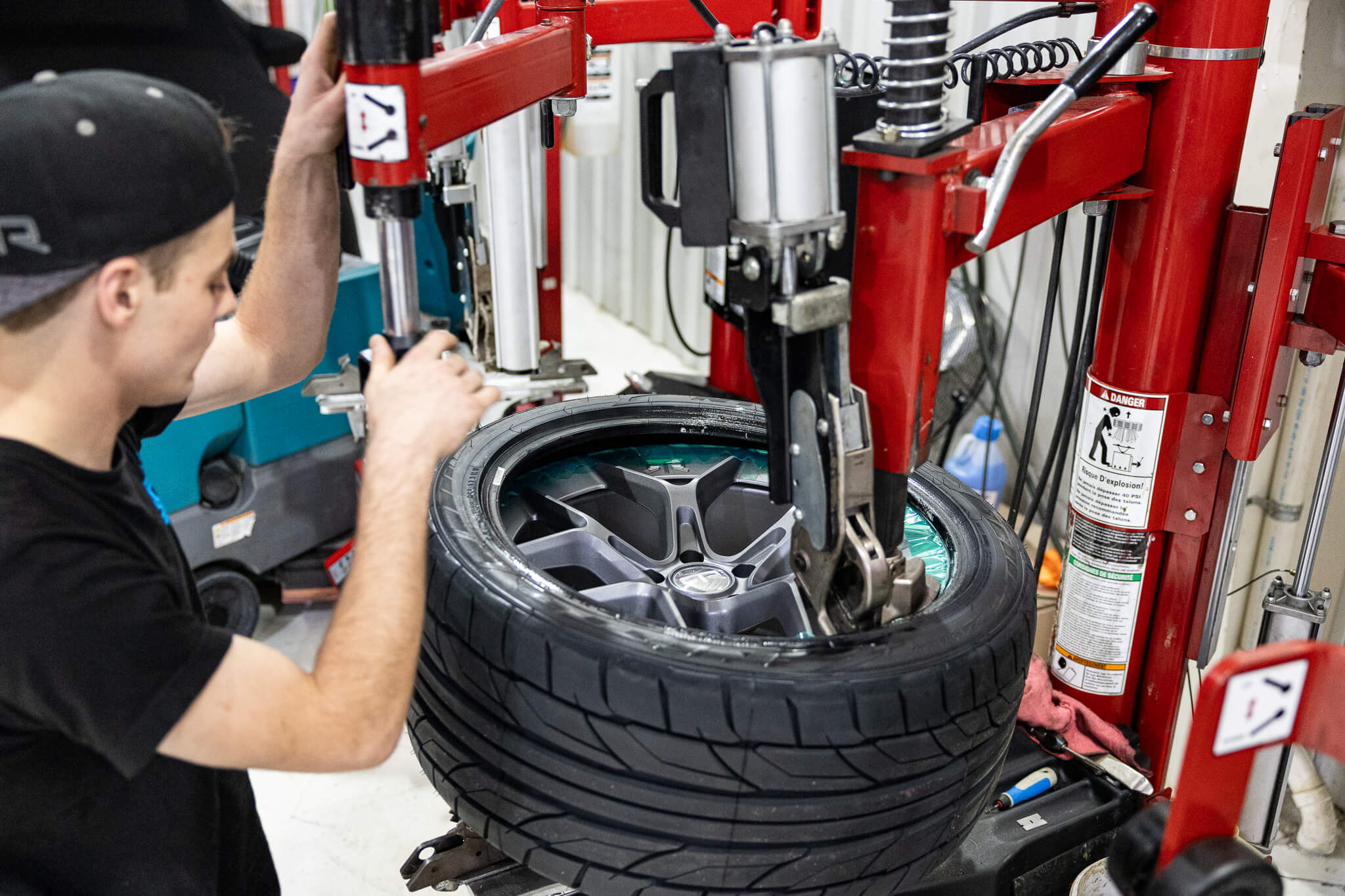 A man mounting tires on a set of RTR Aero 5 wheels