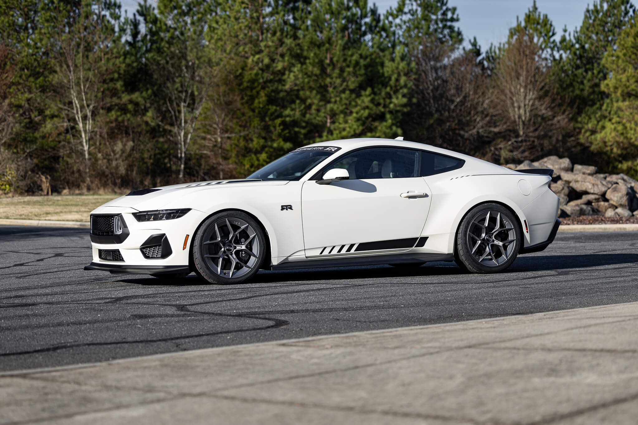 A 2025 Wimbledon white 60th anniversary Mustang RTR on an asphalt road