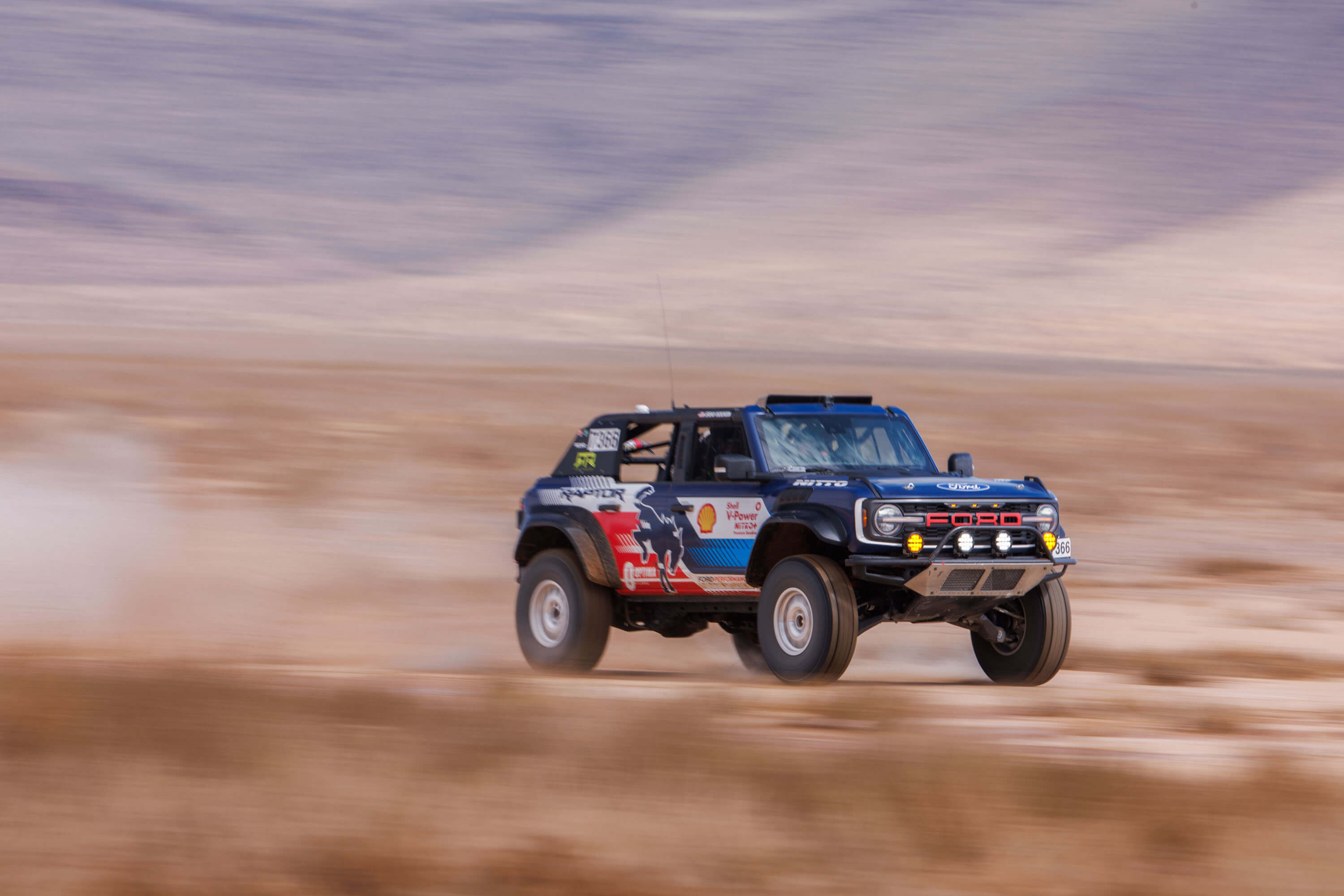 Vaughn Gittin Jr. pushes the Bronco Raptor to its limits, navigating the rough terrain in an intense battle for the podium.