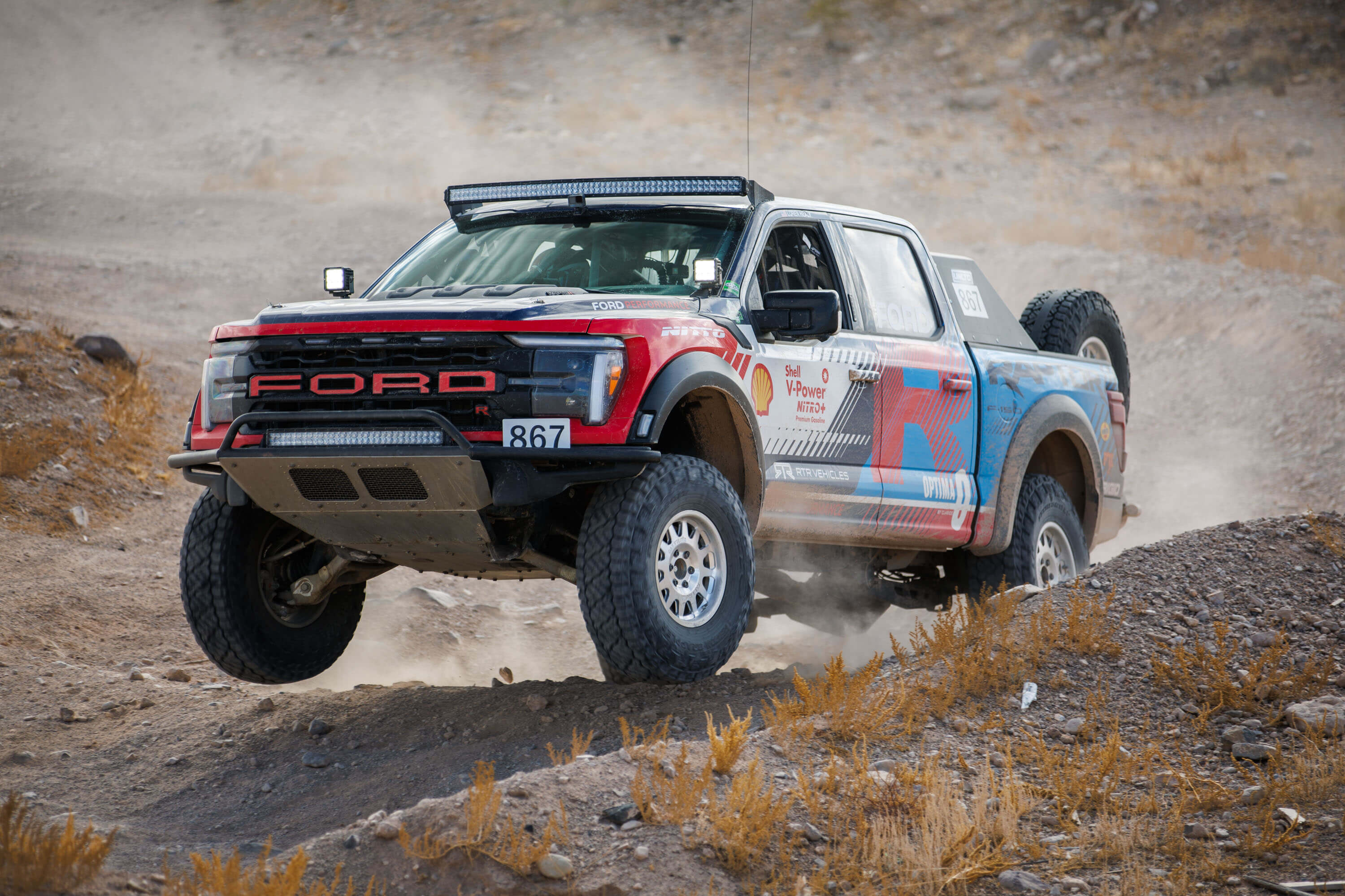 Loren Healy’s F-150 Raptor R catches air as it surges through the course, leading him to victory in the Stock Full-Size Class.