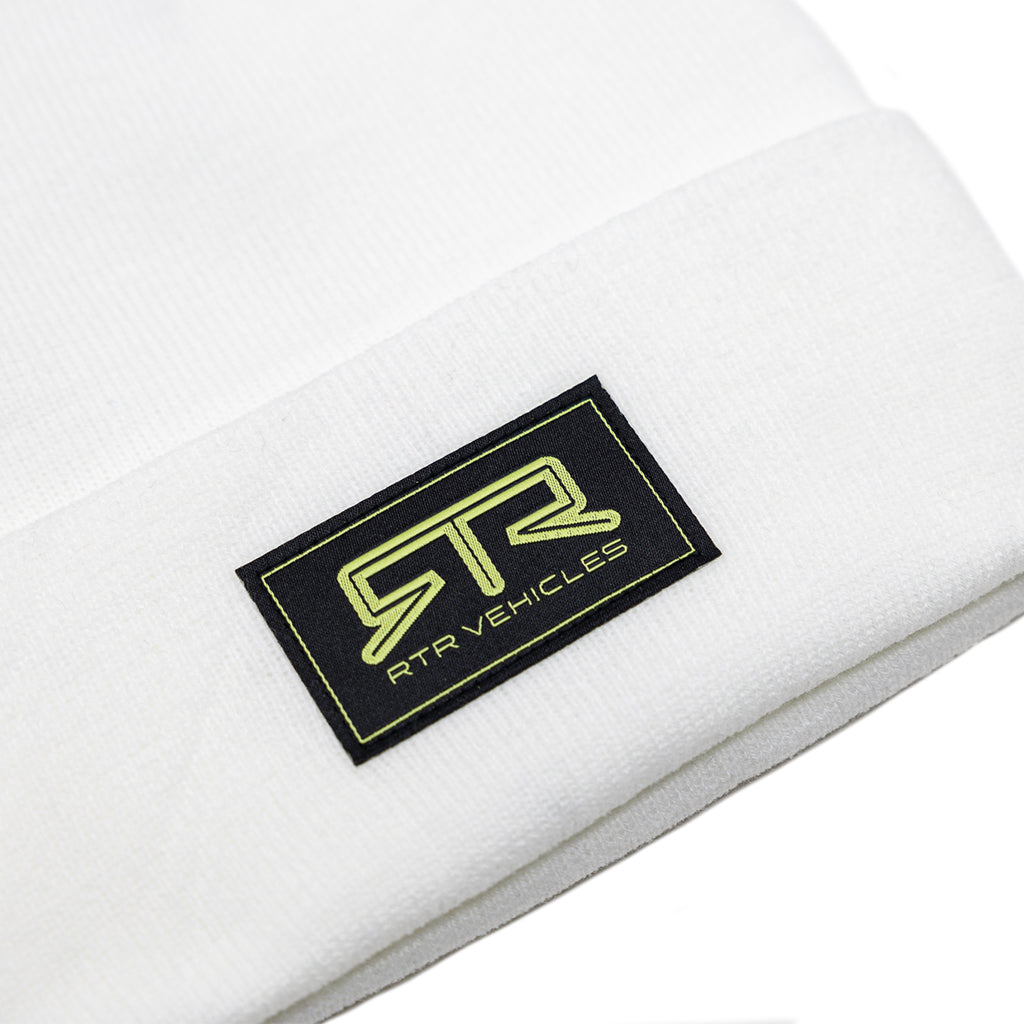 White RTR Beanie with a black label featuring a stitched Hyper Lime RTR logo. Perfect for style and functionality.