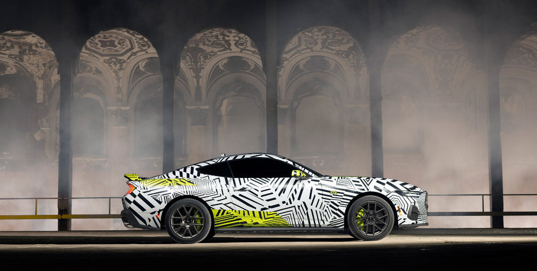 a side view of the Mustang RTR in dazzle camo in a historic building