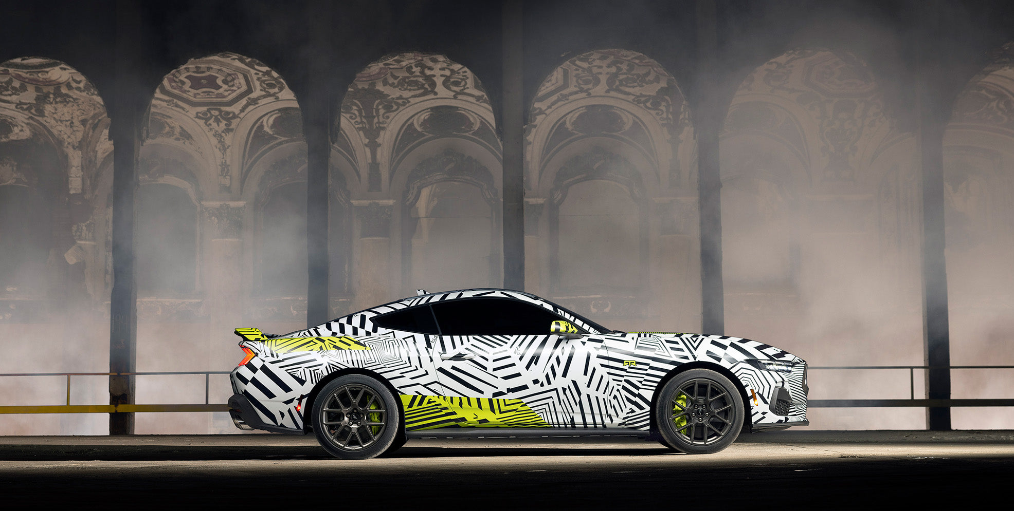 a side view of the Mustang RTR in dazzle camo in a historic building