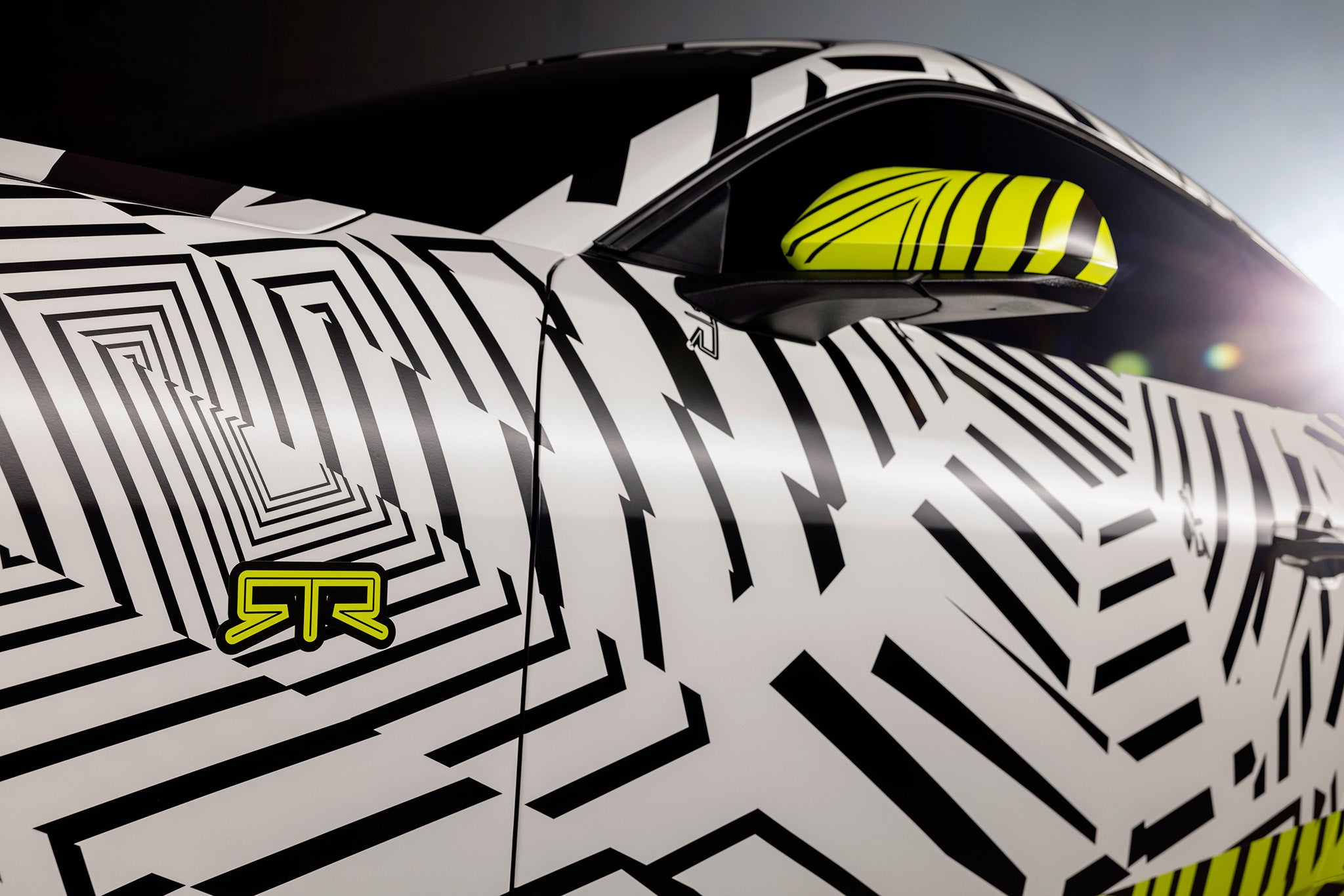 Detailed view of the Mustang RTR's door in Dazzle camo with hyper lime RTR badge