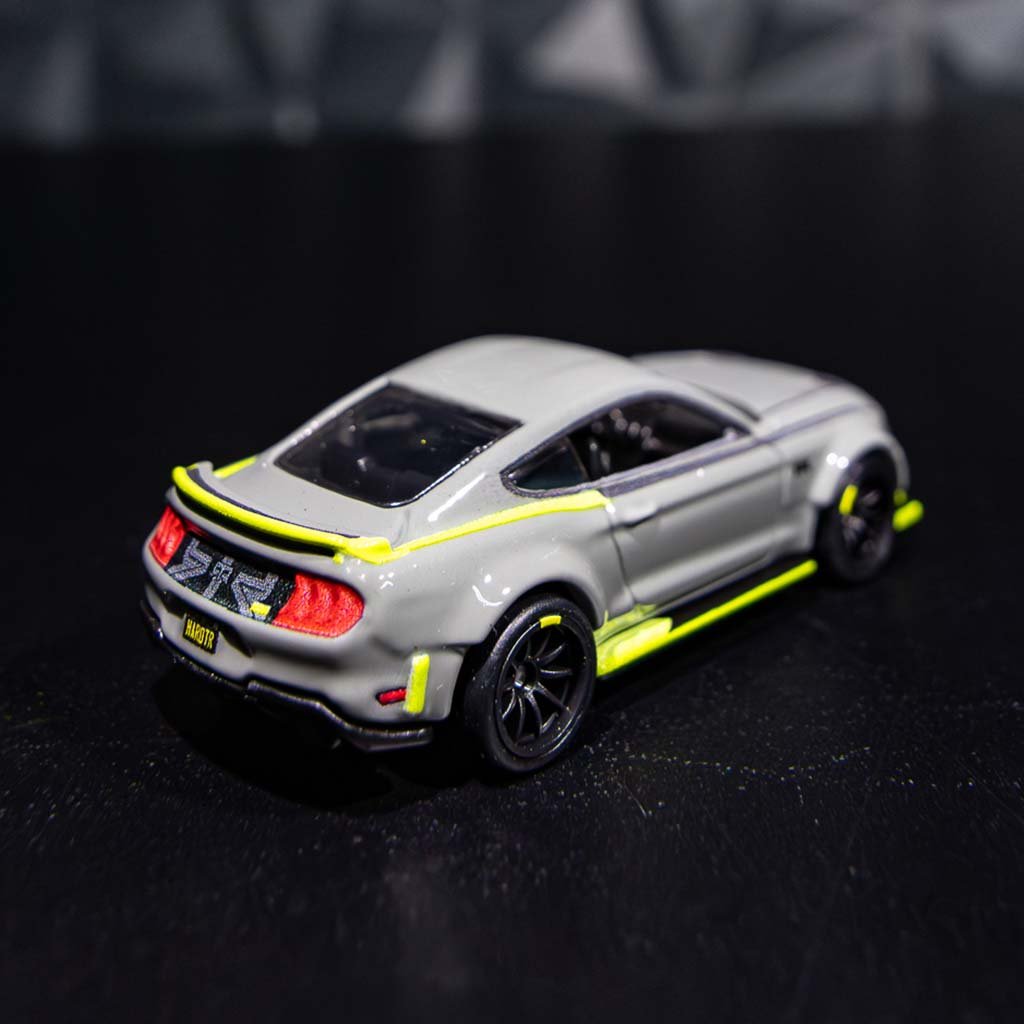 Close-up of the 10th Anniversary Mustang RTR Spec 5 Hot Wheels toy car, showcasing detailed Forged Wheels, Widebody Flares, and unique decals.