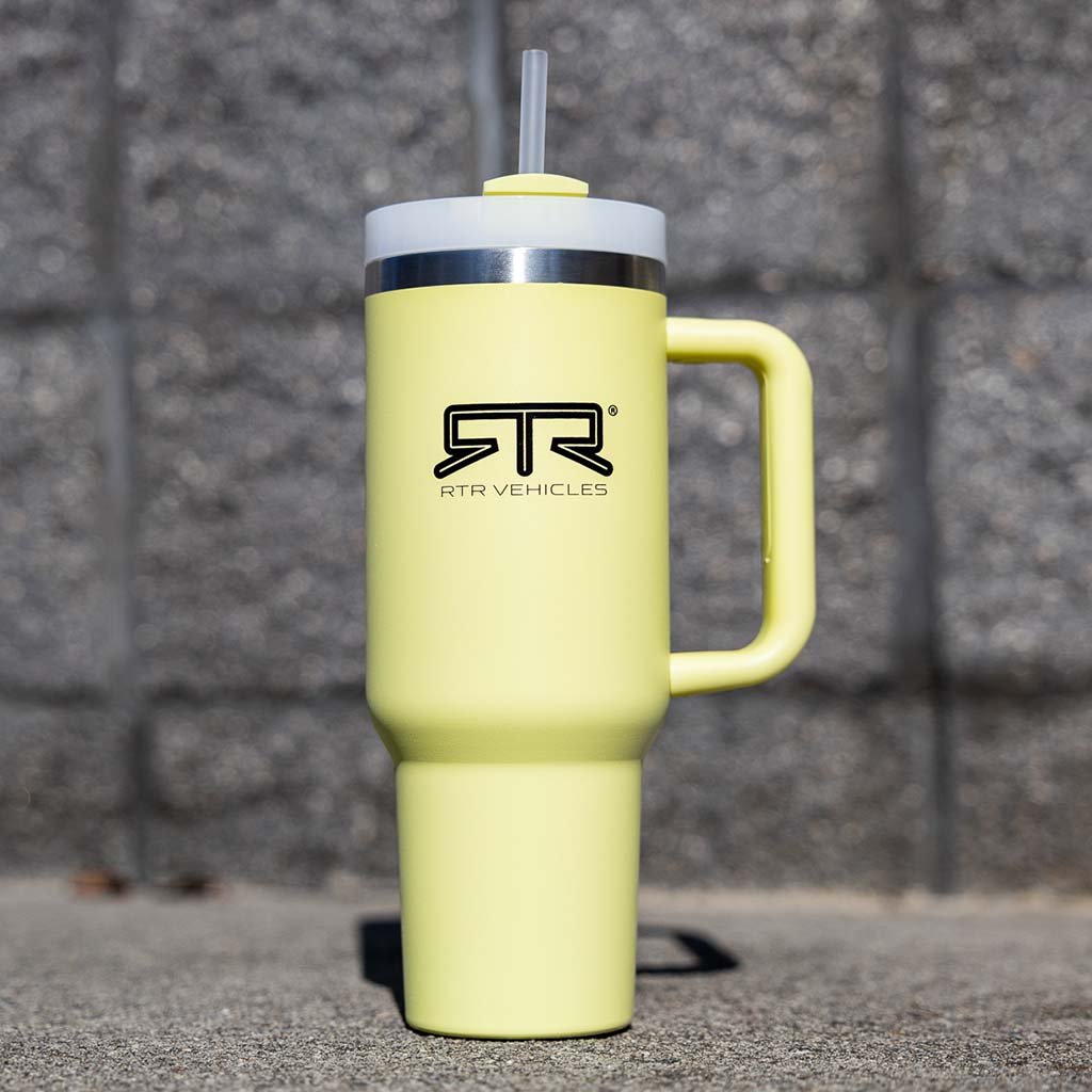 RTR 40oz Tumbler, a stainless steel container with a spill-resistant lid and straw, featuring the engraved RTR Vehicles logo for a sleek appearance.