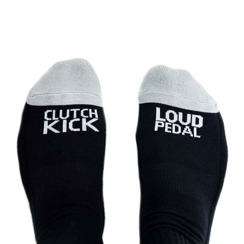 RTR Socks featuring black design with grey Clutch Kick and Loud Pedal text, offering comfort and unique style for any occasion.