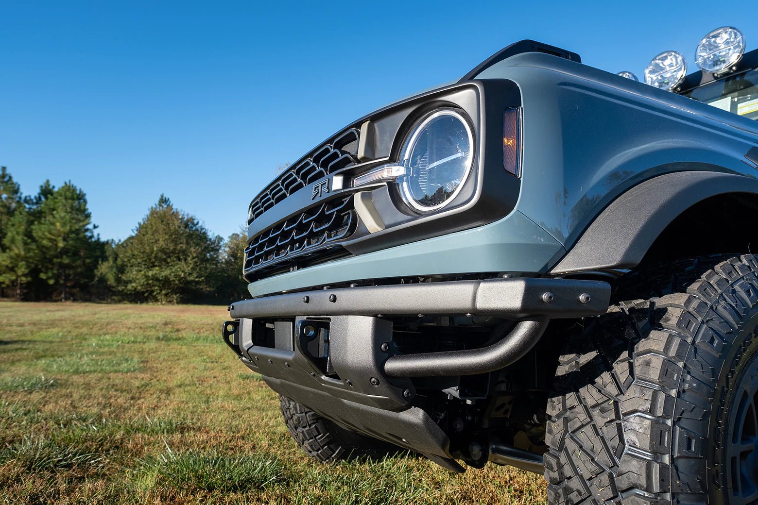 Close-up of the Bronco Trail Safe Package featuring rugged rock sliders and bumper enhancements designed for off-road durability on a 21+ Bronco with modular front bumper.